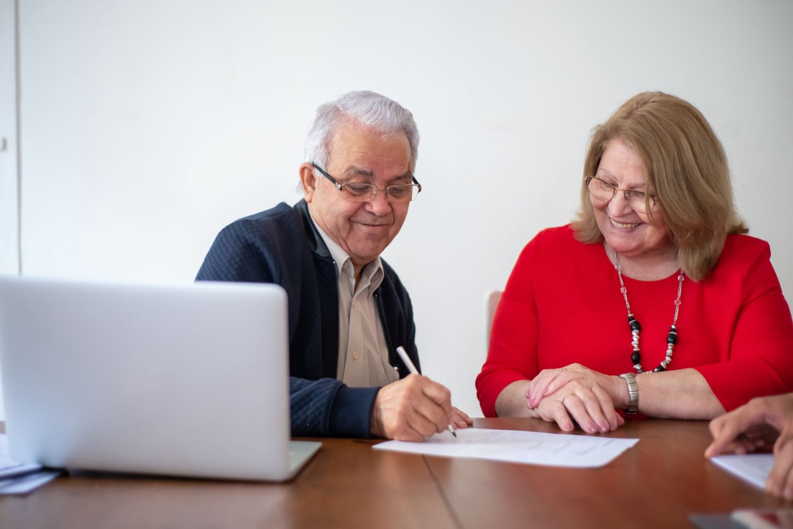 Un couple signe un contrat avec un prestataire de mariage